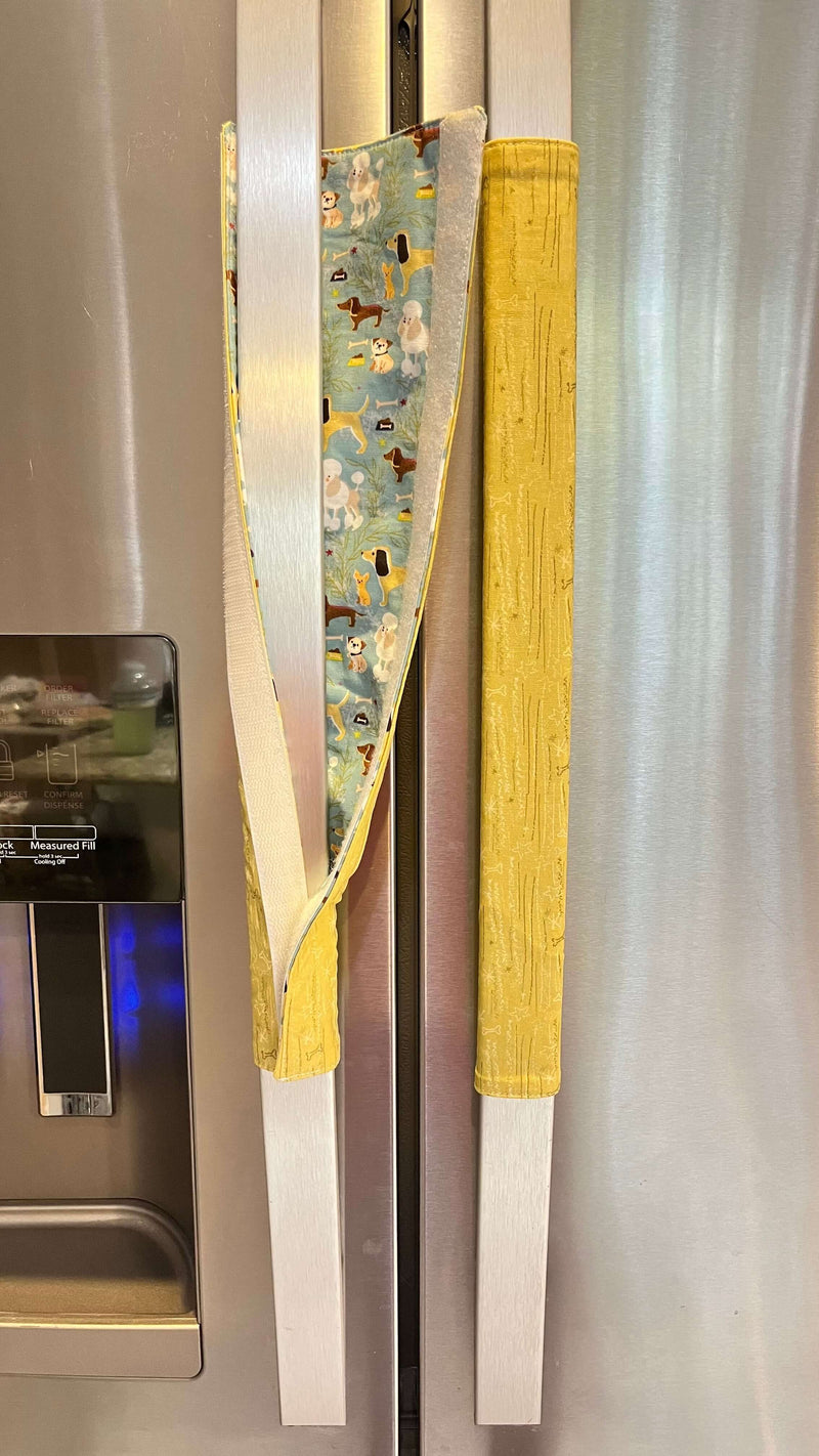 Cute puppy print on appliance handle covers adding charm to a refrigerator.