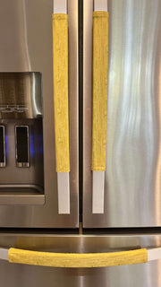 Cute puppy print on appliance handle covers enhancing a refrigerator's aesthetic with playful yellow color.