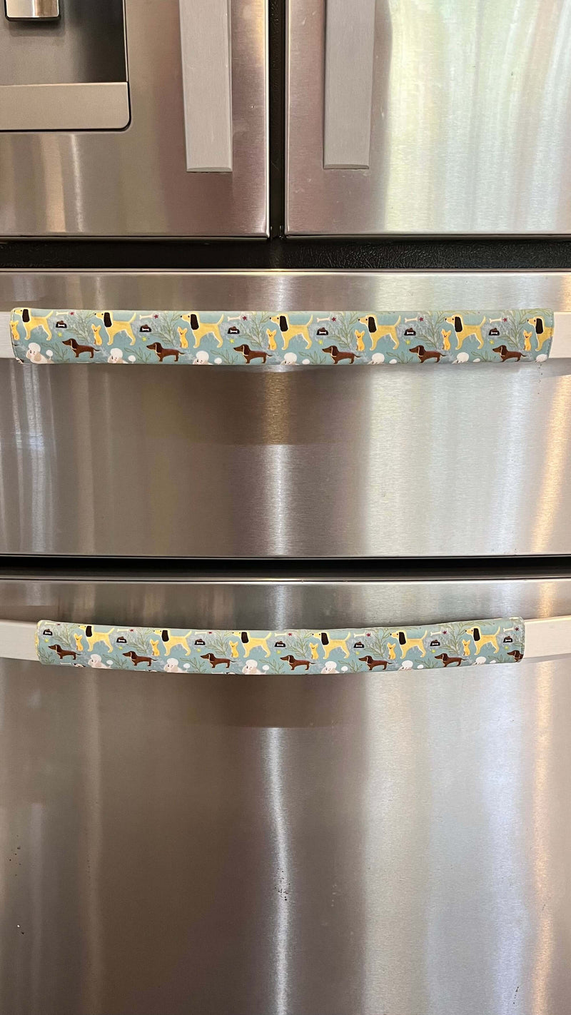 Cute puppy print on appliance handle covers on stainless steel refrigerator.