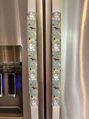 Cute puppy print on appliance handle covers displayed on refrigerator handles.