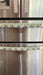 Cute puppy print on appliance handle covers on stainless steel refrigerator.