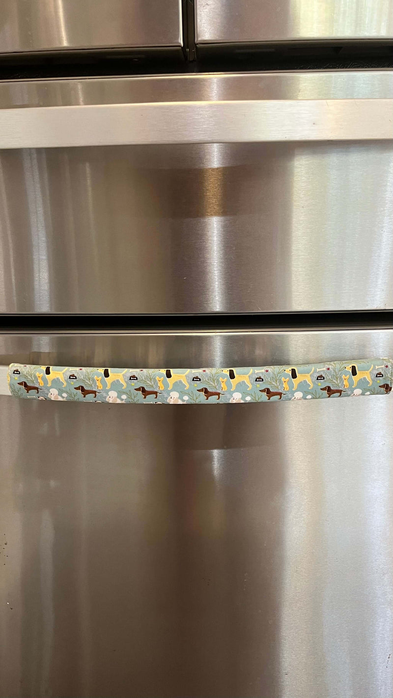 Cute puppy print on appliance handle covers on a refrigerator handle, adding a playful touch to kitchen decor.