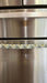 Cute puppy print on appliance handle covers on a refrigerator handle, adding a playful touch to kitchen decor.