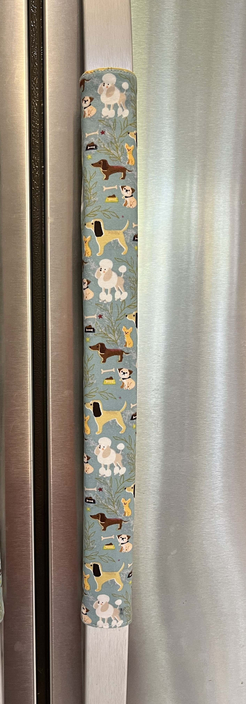 Cute puppy print on appliance handle covers featuring various dog designs on a blue background.