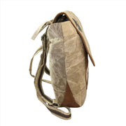 Eco-friendly canvas backpack side view showing upcycled materials and adjustable straps.
