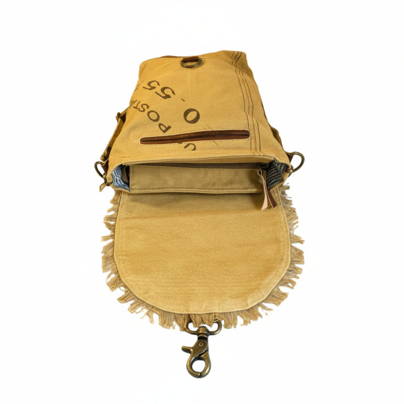Eco-friendly canvas leather flap shoulder bag with fringe detailing and zippered pocket.