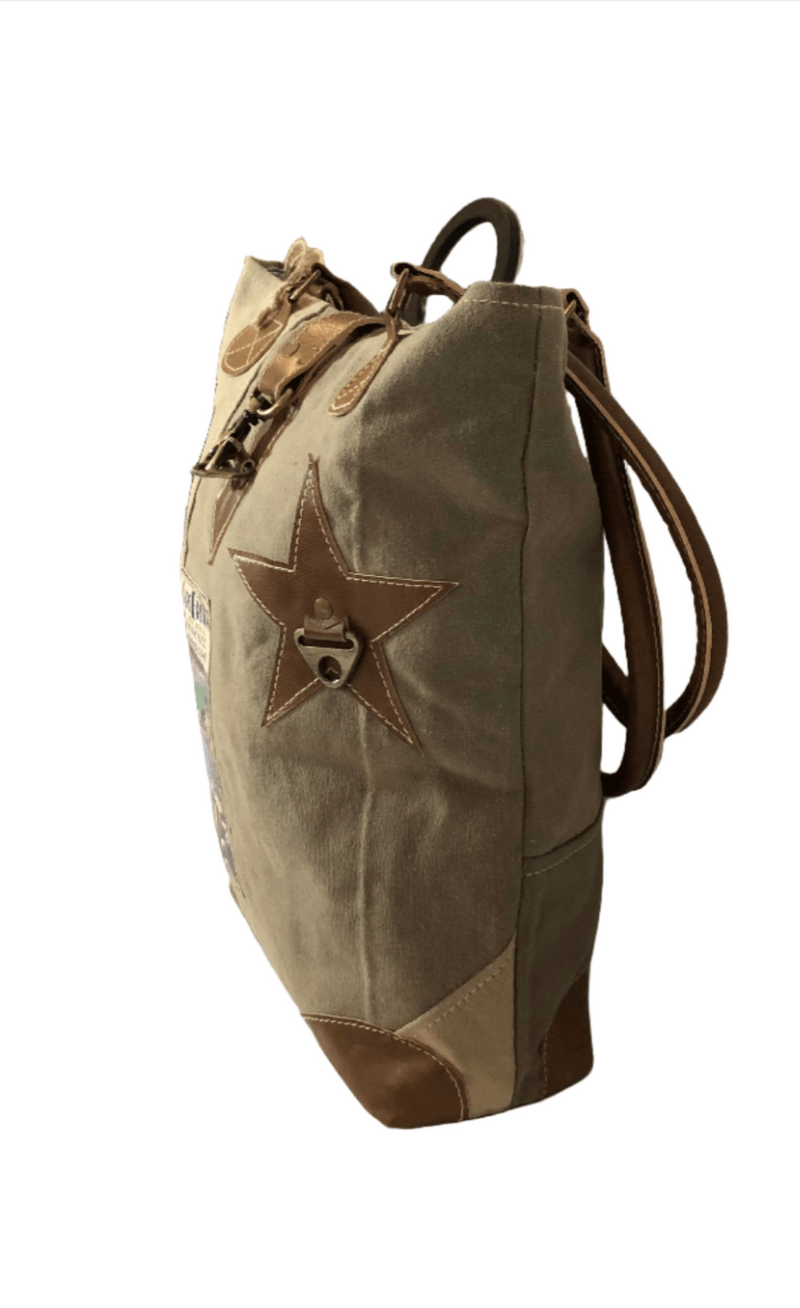 Eco-friendly Cape Breton tote bag featuring leather star and unique patchwork design, perfect for casual outings.