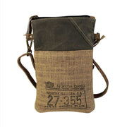 Eco-friendly passport bag made from repurposed military tent and canvas, featuring burlap and leather design.