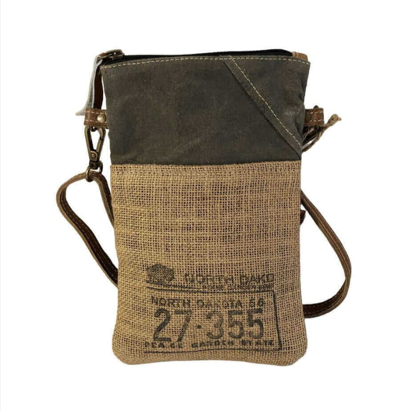 Eco-friendly passport bag made from repurposed military tent and canvas, featuring burlap and leather design.