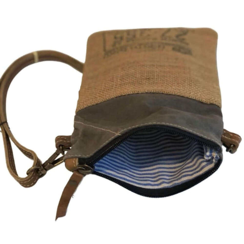 Eco-friendly passport bag featuring burlap and leather design, unzipped showing interior stripes.