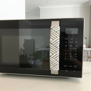Geometric Refrigerator Handle Covers - Grey and White on a microwave handle, enhancing modern kitchen decor.