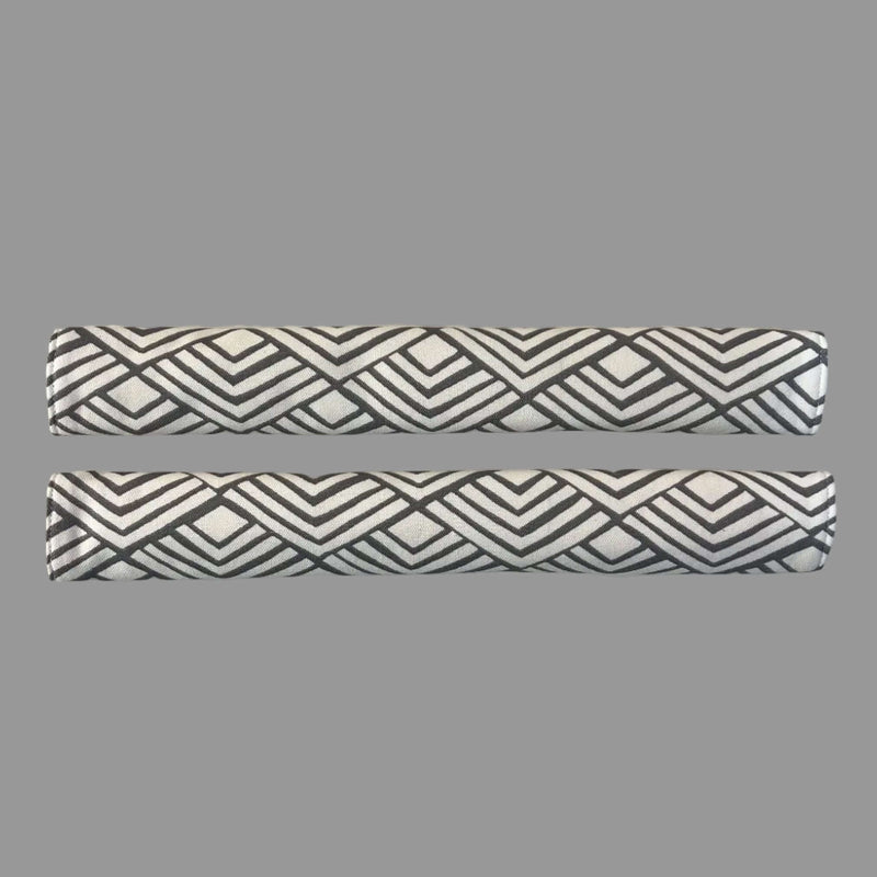 2 horizontal appliance handle covers  with geometric patterns on a white surface 