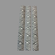 Three appliance handle covers  with geometric patterns on a grey surface