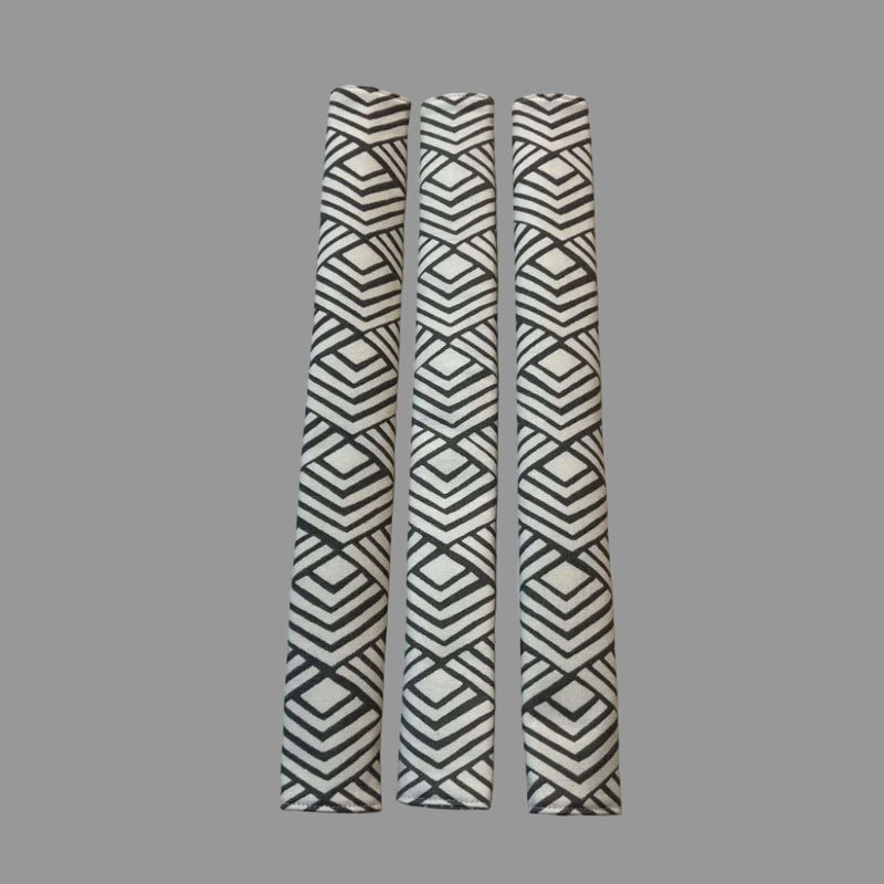 Three appliance handle covers  with geometric patterns on a grey surface