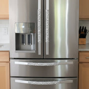 Geometric Refrigerator Handle Covers - Grey and White on modern stainless steel refrigerator, adding style and protection.