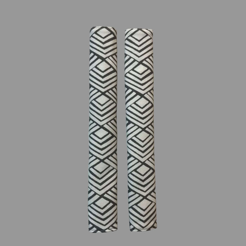 2 vertical appliance handle covers  with geometric patterns on a white surface