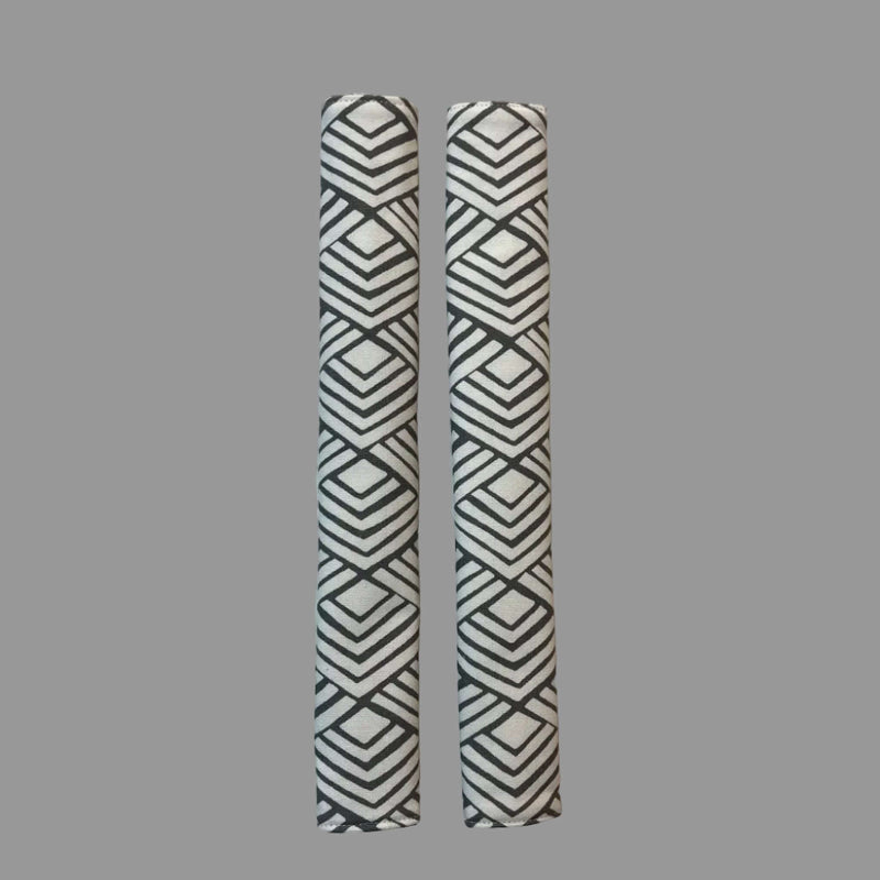 2 vertical appliance handle covers  with geometric patterns on a white surface