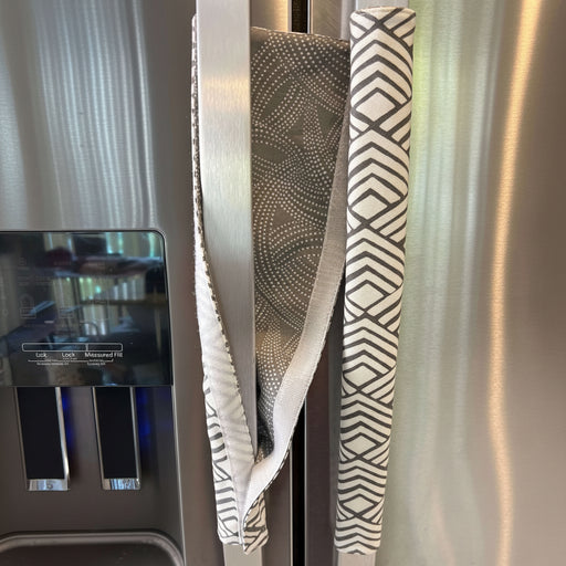 Geometric Refrigerator Handle Covers - Grey and White on stainless steel fridge, adding style and protection.