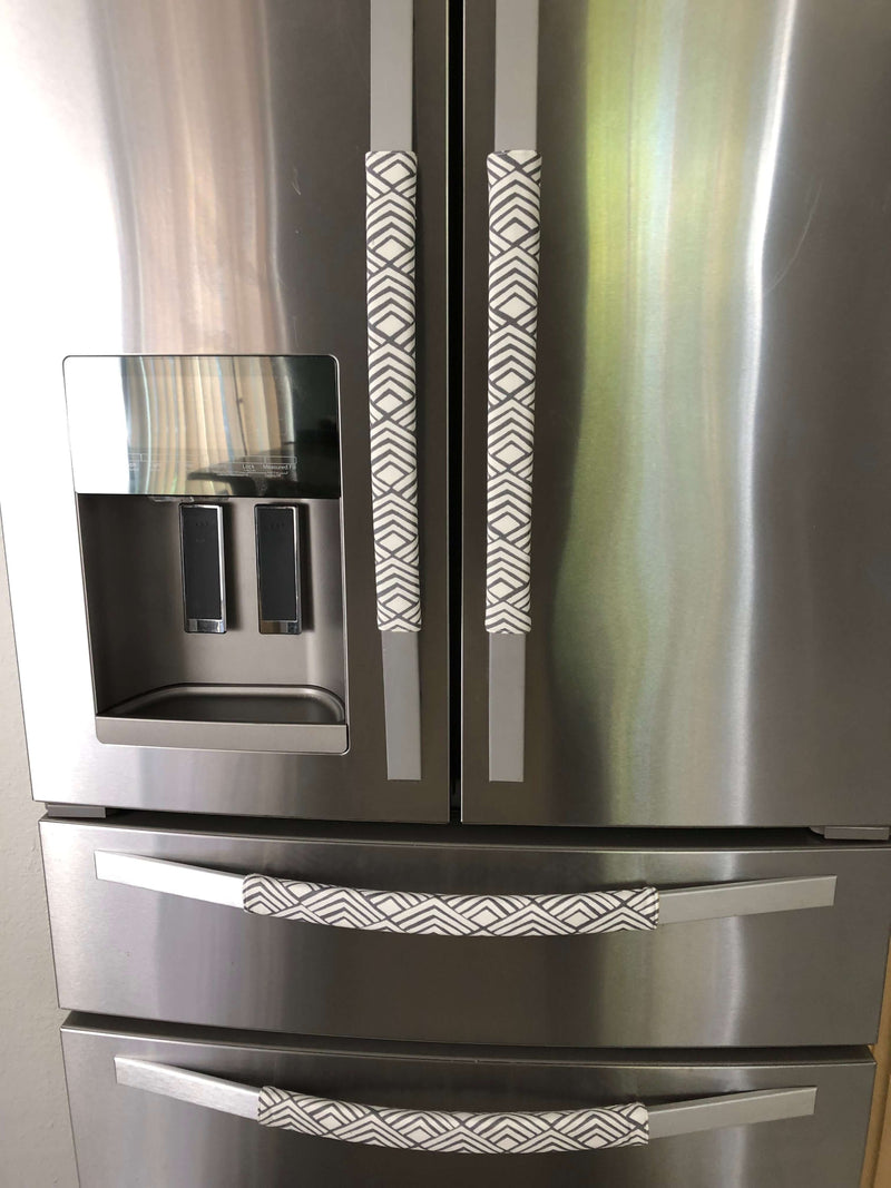 Geometric Refrigerator Handle Covers - Grey and White on modern stainless steel refrigerator, adding style and protection.