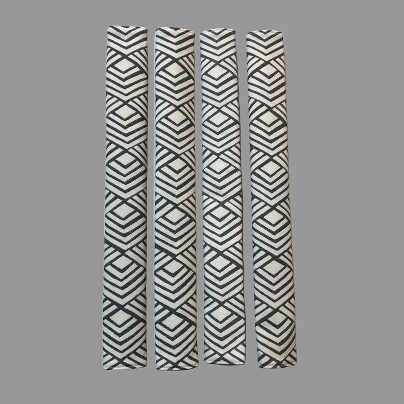 Four vertical appliance handle covers  with gray geometric patterns on a white surface 