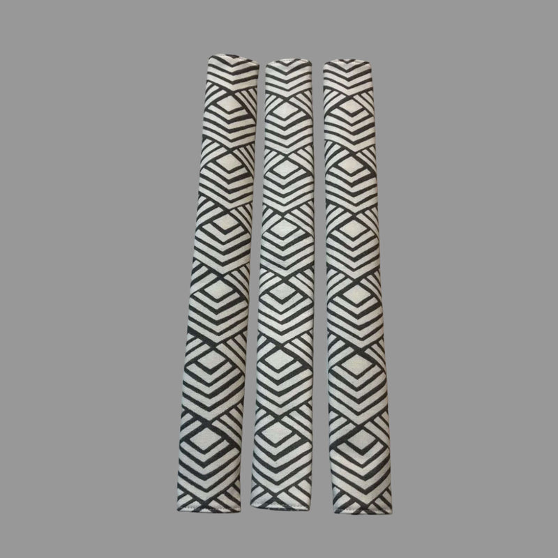 Three appliance handle covers  with geometric patterns on a white surface