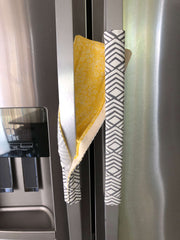 Geometric Refrigerator Handle Covers - Grey and White on stainless steel fridge, featuring modern patterns and colors.