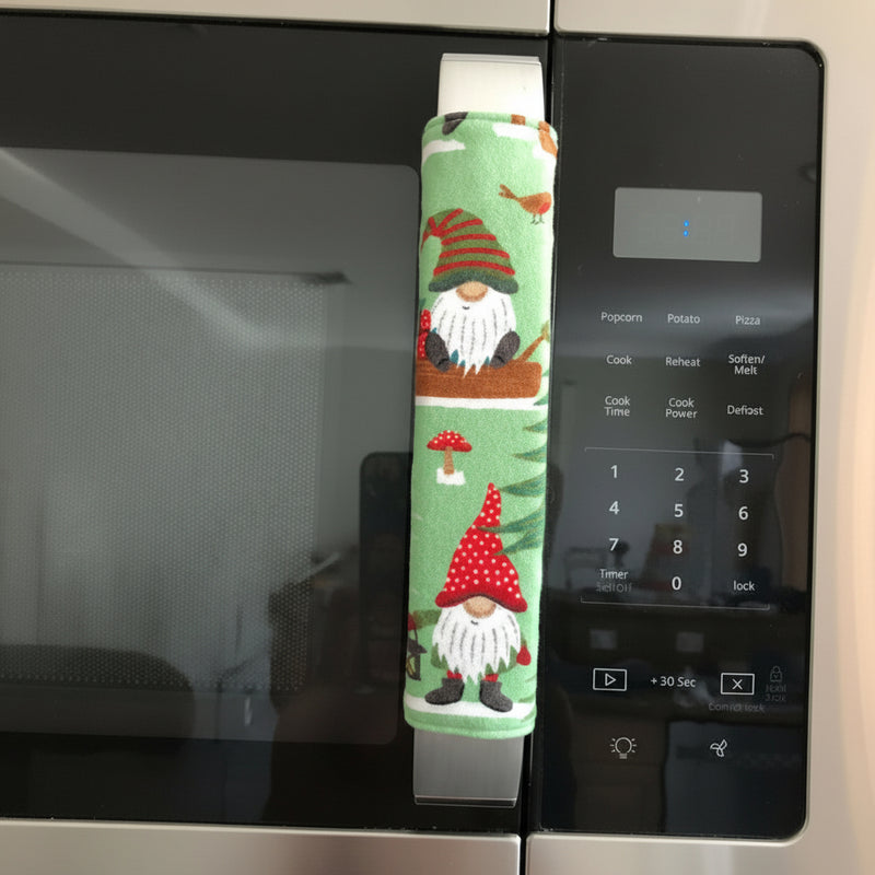 Gnomes on The Green Christmas Appliance Handle Covers on a refrigerator handle, festive kitchen decor for the holiday season.