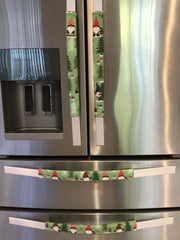 Gnomes on The Green Christmas Appliance Handle Covers on refrigerator handles in festive colors.