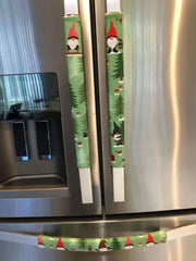 Gnomes on The Green Christmas Appliance Handle Covers on refrigerator handles in festive green, red, and white colors.
