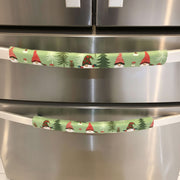 Gnomes on The Green Christmas Appliance Handle Covers on refrigerator handle in festive green, red, and white design.
