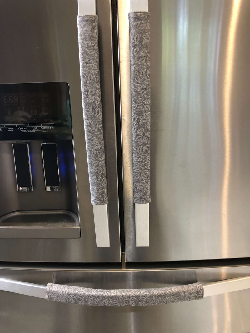 Grey Leaf Motif Appliance Handle Covers on stainless steel refrigerator, adding style and protection.