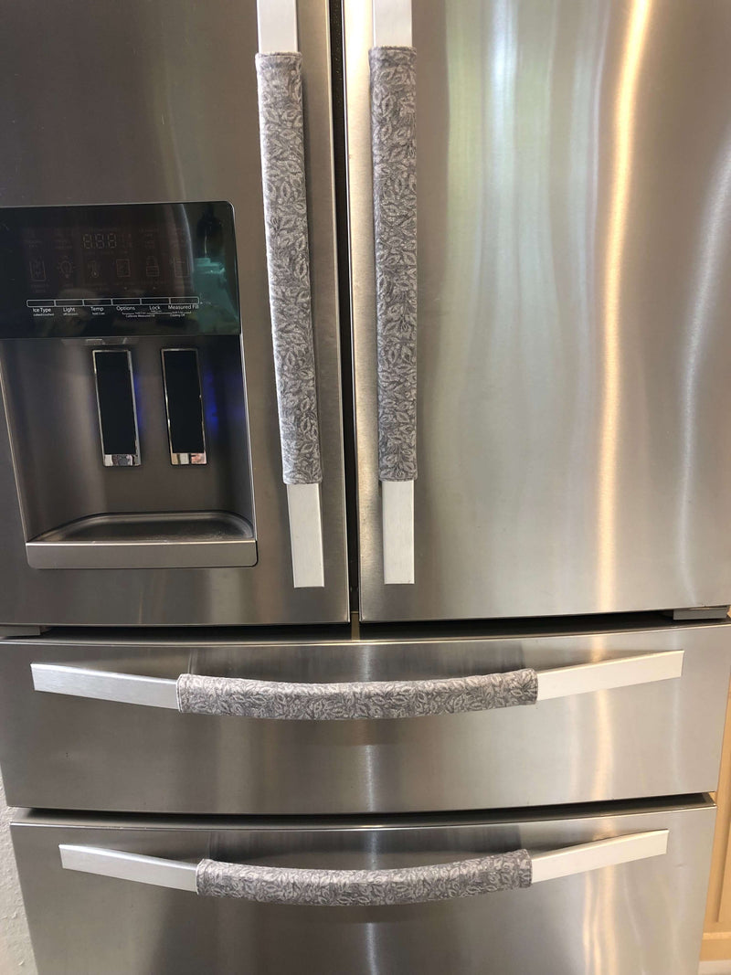 Grey Leaf Motif Appliance Handle Covers on stainless steel refrigerator handles for added style and cleanliness.