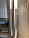 Grey Leaf Motif Appliance Handle Covers on stainless steel refrigerator doors.