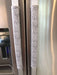 Grey and white gerbera daisy handle covers for kitchen appliances on stainless steel refrigerator handles.
