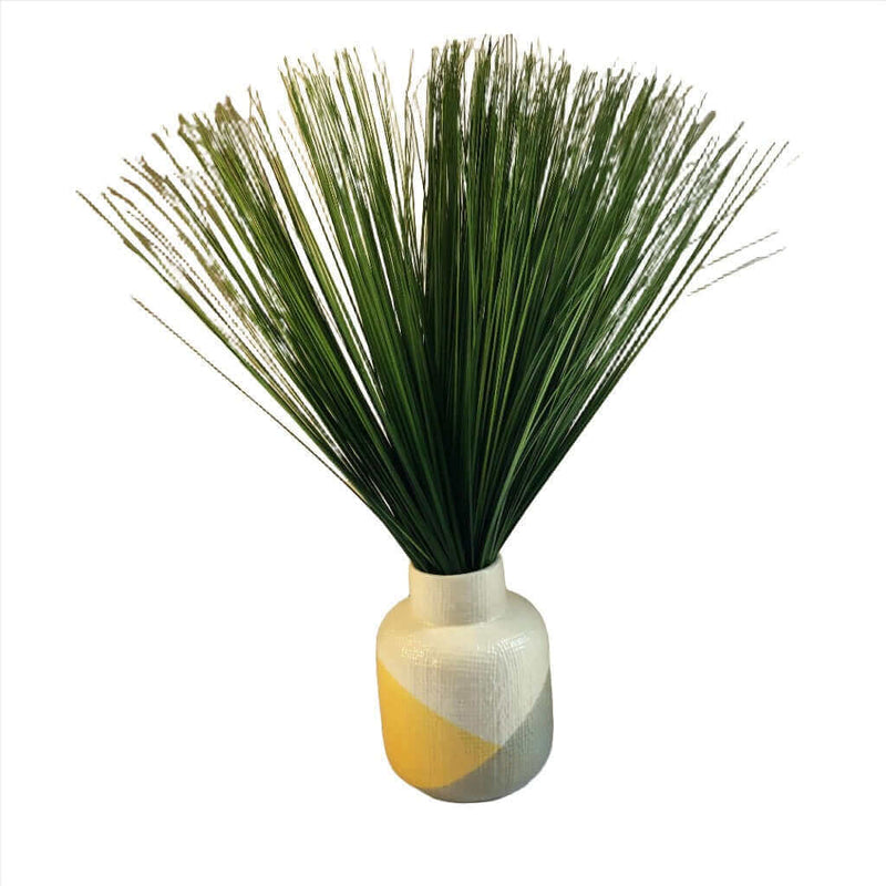 Grey yellow and white ceramic vase with cylindrical shape and green foliage, perfect for modern home decor.