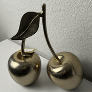 Brass Metal Table-Top Cherries decorative accent pieces with a leaf detail, adding charm and elegance to home decor.