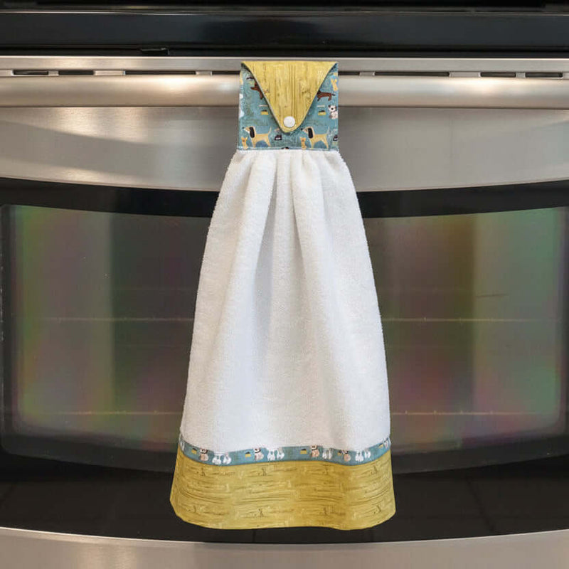 Abstract painting on a wall with a decorative towel hanging below.