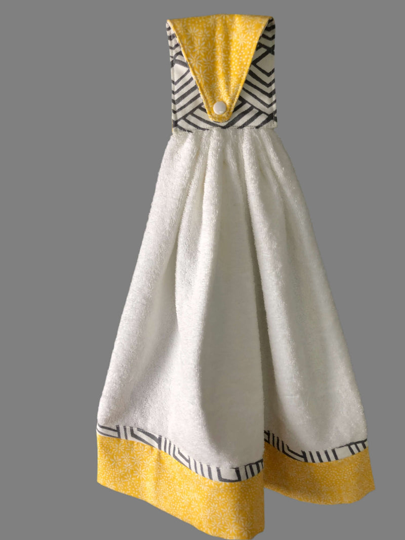 Handmade geometric kitchen hand towel in white and yellow with stylish patterns and convenient hanging loop.