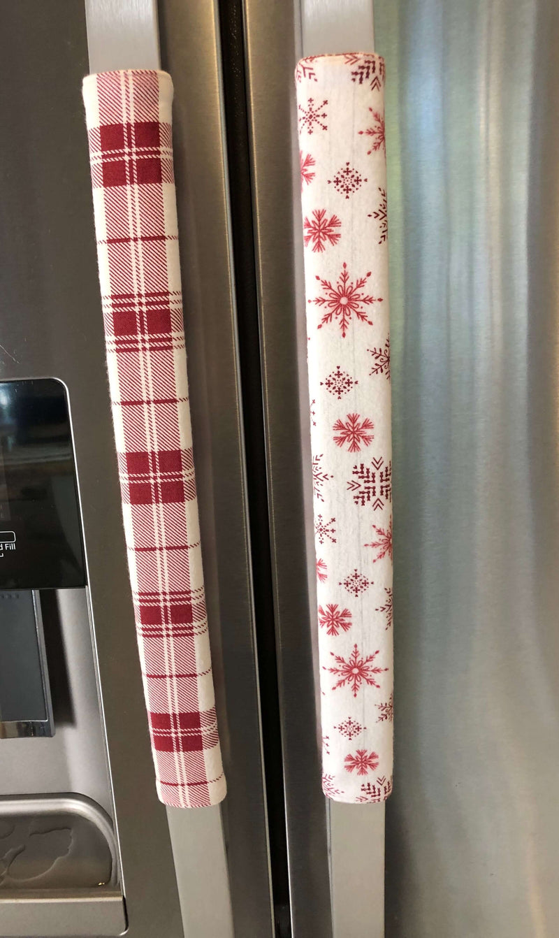 Rose pink snowflake appliance handle covers on kitchen refrigerator, adding a festive touch to kitchen decor.