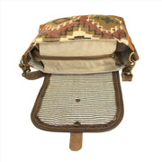 Jewel toned canvas shoulder bag with flap closure, showcasing interior compartments and stylish lining.