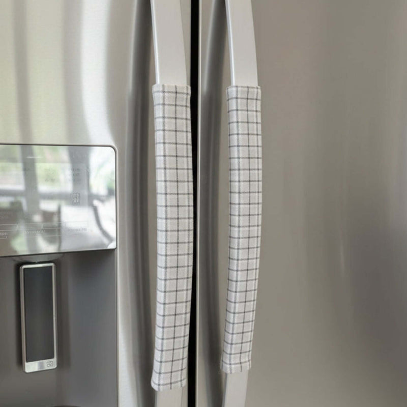 Stainless steel fridge with light grey handle covers