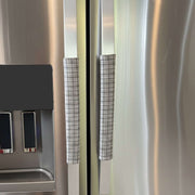 Stainless steel refrigerator with grey plaid handle covers