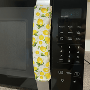 Pastel Mint Green & Lemon Print-Reversible Refrigerator Handle Covers on a microwave handle.