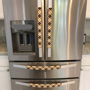 Plaid-patterned handle covers on a stainless steel appliance. 