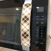 Plaid-patterned handle covers on a microwave