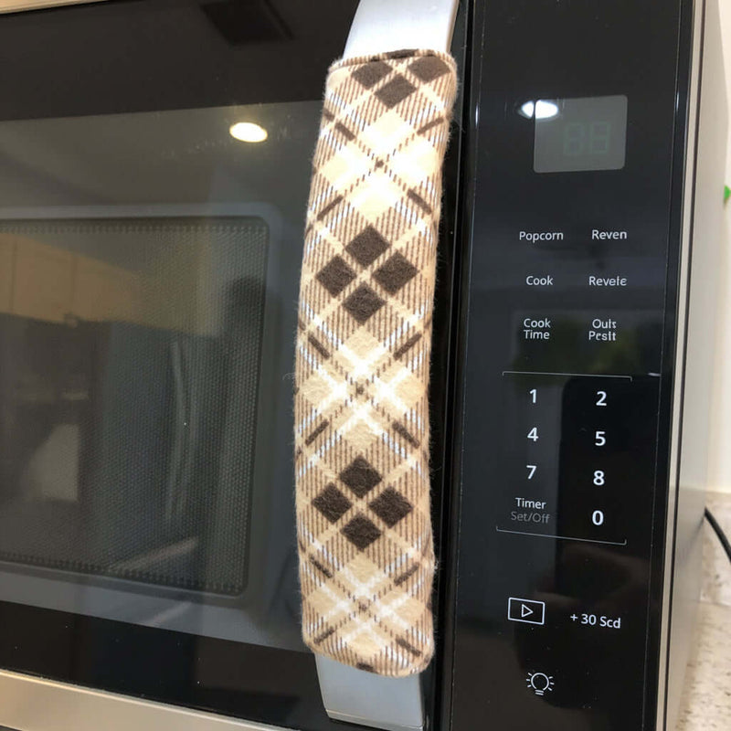 Plaid-patterned handle covers on a microwave