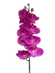 Fuchsia colored artificial orchid on a textured white background