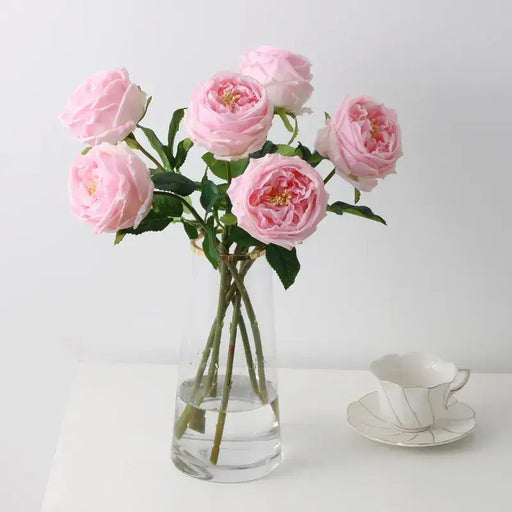 Real Touch Royal Peony Artificial Stem in a vase with pink flowers and a teacup on a table.