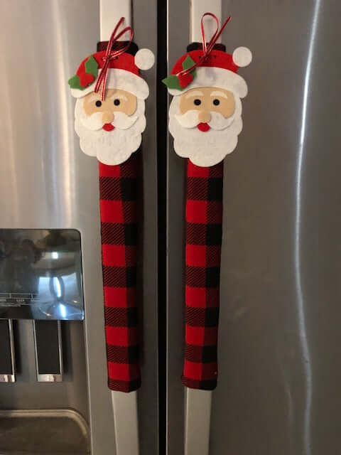 Red and black buffalo check appliance handle covers featuring Santa design for festive kitchen decor.