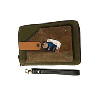 RFID passport utility wristlet featuring upcycled leather and canvas, RFID protection, and secure card slots.